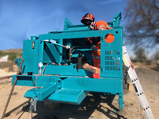 Man fixing a heavy plant
